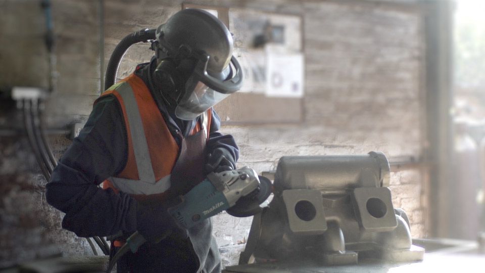 worker grinding metal